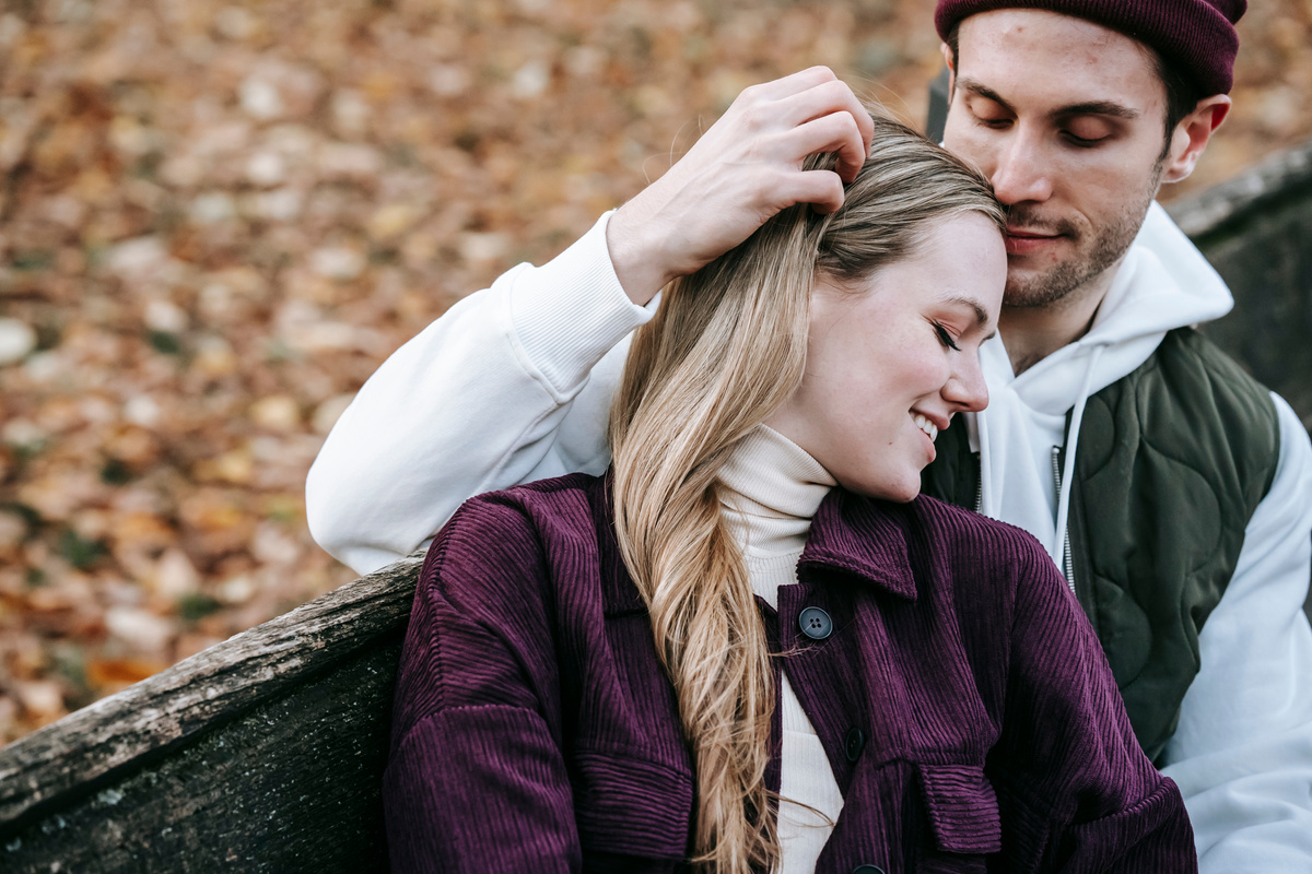 Happy couple relaxing and embracing in park